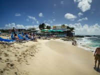 Pretty much an about face from the previous shot shows you the Sunset Beach Bar where a sign says &#34;topless ladies drink free!&#34;. There weren&#39;t any topless ladies during the day that I noticed but I know it does occur occasionally in the evening. About where I&#39;m standing is right on the glide path for the runway.